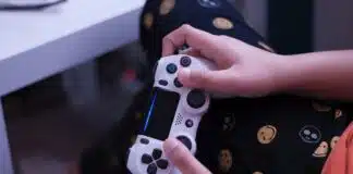 person holding white sony ps 4 controller